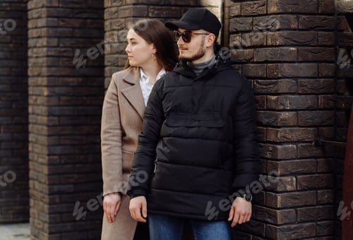 Preview: Young couple posing near wall