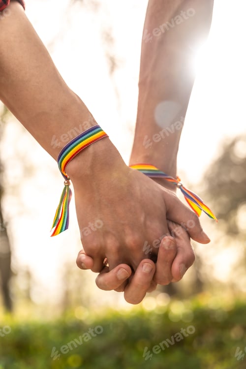 Preview: Gay men with rainbow bracelets holding hands