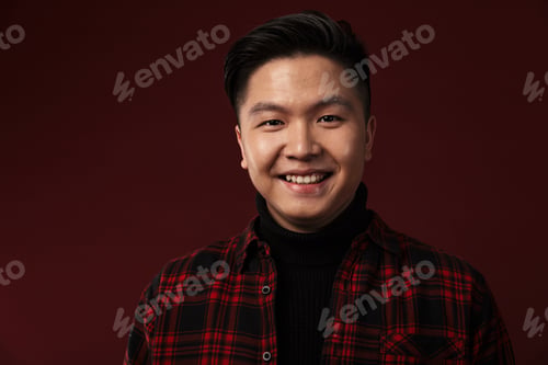 Preview: Image of cheerful asian man smiling and looking at camera