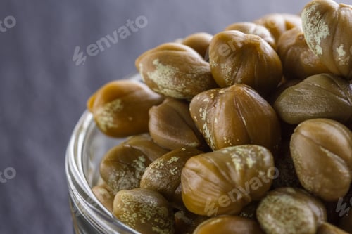Preview: pickled capers on a dark stone background