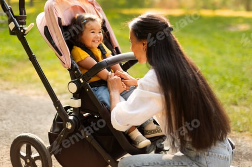 Preview: Loving Mother Interacting With Toddler in Stroller