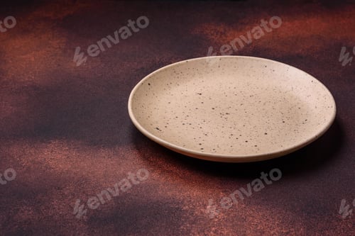 Preview: Empty ceramic round plate on dark textured concrete background