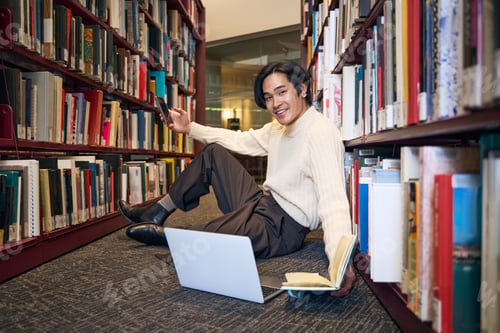 Preview: Asian student studying, learning language, exam preparation sitting in university library, education