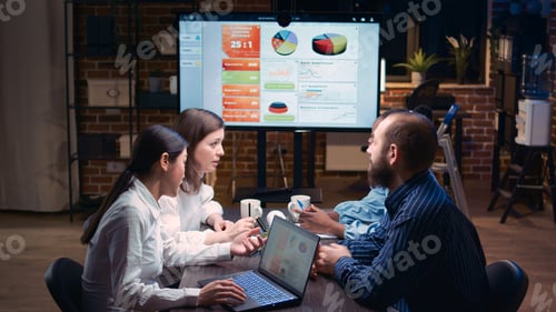 Preview: Diverse business team duscussing report statistics on presentation meeting