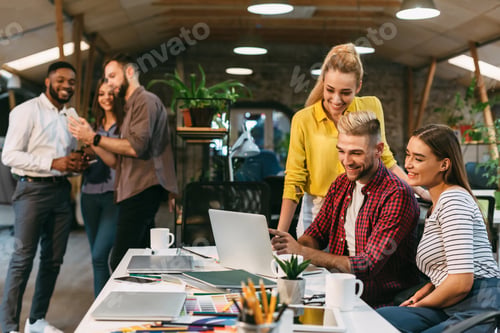 Preview: Young web designers working together at modern office