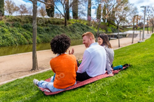 Preview: Friends enjoying sunny day in park by river