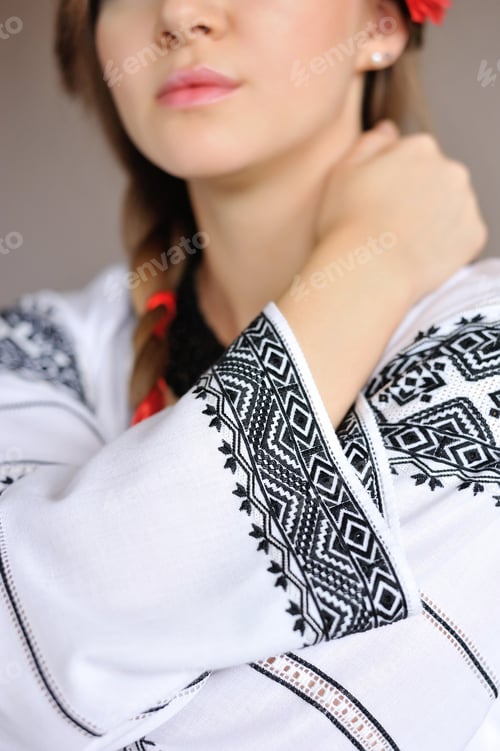 Preview: The girl in an embroidered shirt. Closeup detail of embroidered