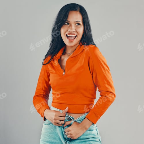 Preview: Mixed race woman isolated against grey background in studio with copyspace and feeling flirty. Youn