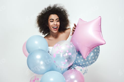Preview: What is there Excited and happy afro american woman with curly hair looking from behind colourful