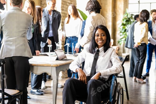 Preview: Young African American business woman on wheelchair smiling and looking at the camera