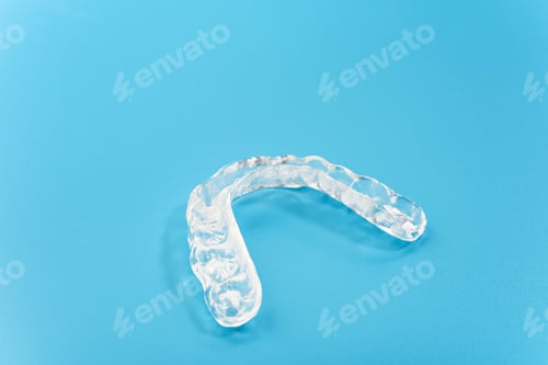 Preview: Dental aligner used by dental doctors isolated on blue background.