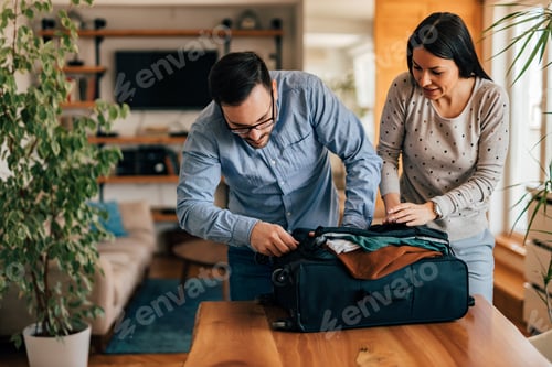 Preview: Wife helping husband pack for a travel, portrait.