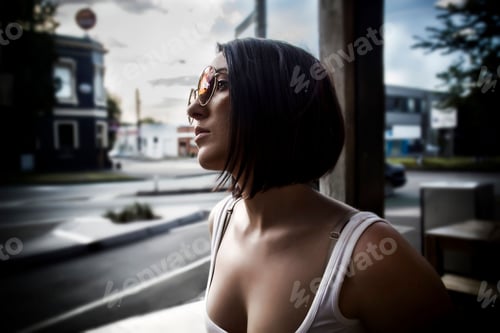 Preview: Closeup shot of a female looking out a window with a gloomy expression