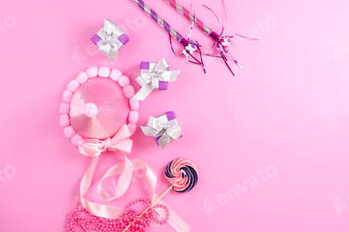 Preview: a top view purple gift boxes along with pink cap lollipop and birthday whistles on the pink