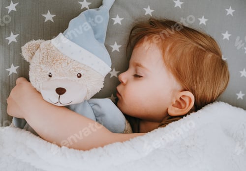 Preview: Little baby girl sleeping with her bear toy.