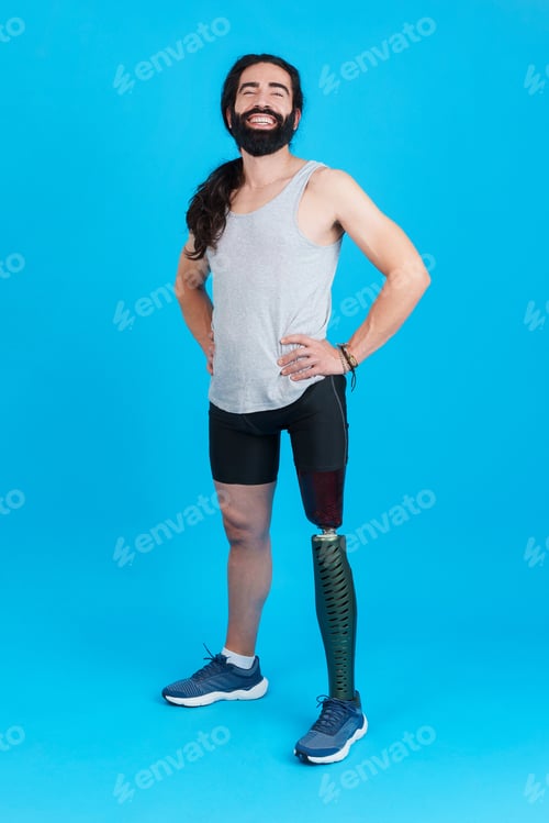 Preview: Sportive man standing and smiling with a leg prosthesis