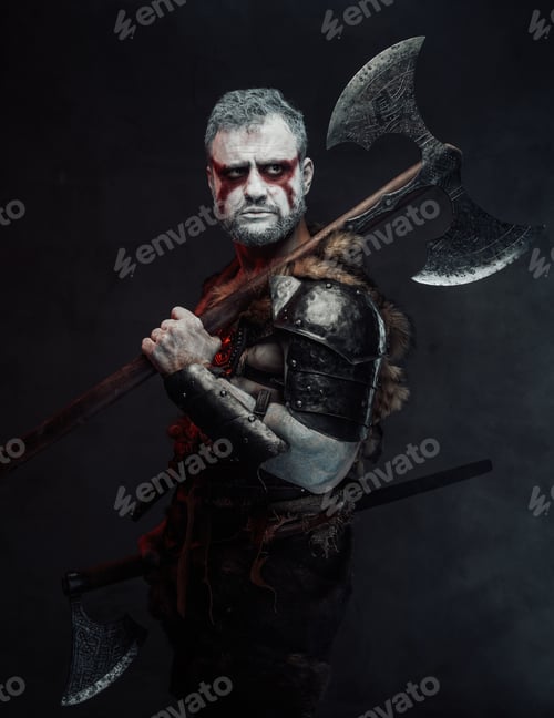 Preview: Serious and violent warrior from fantasy with two axes in studio