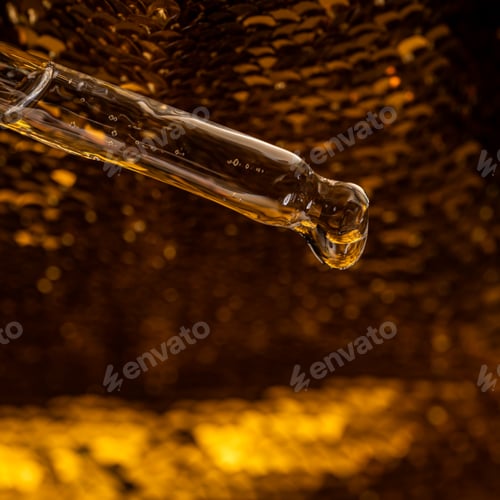 Preview: Bottle pipette dropper close up and Liquid yellow-orange retinol or vitamin c gel or serum