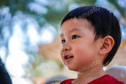 Preview: Portrait of Cute kid thinking at the park.