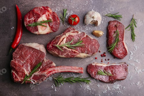 Preview: Flat lay composition with pieces of raw beef, salt, rosemary and products on brown textured table