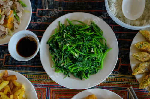 Preview: Plate with seaweed and soy sauce, surrounded by traditional dishes on a Vietnamese table.