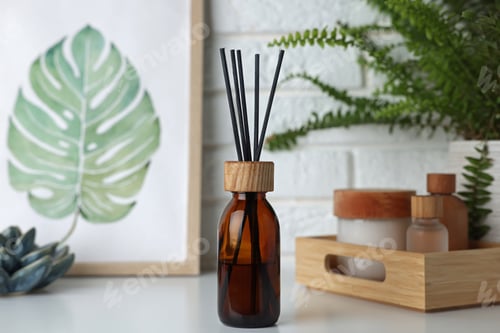 Preview: Air reed freshener, decor and cosmetic products on white table indoors