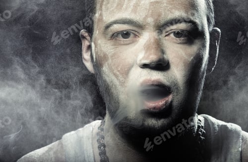 Preview: Man smudged by the dust smoking on a black background