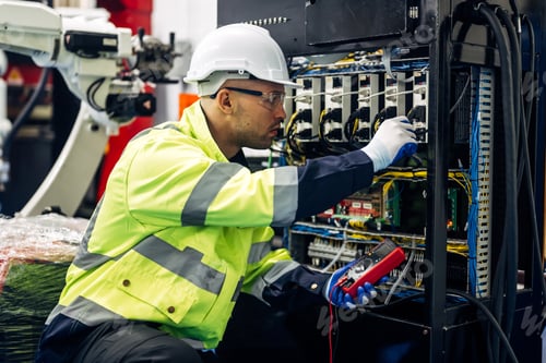 Preview: Technician engineer holding robot controller checking automatic robotic machine