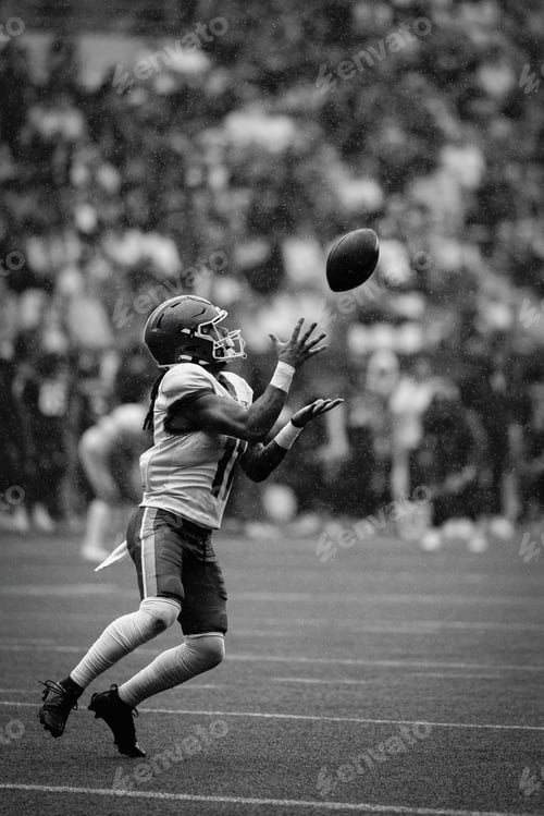 Preview: Football player catching in rain
