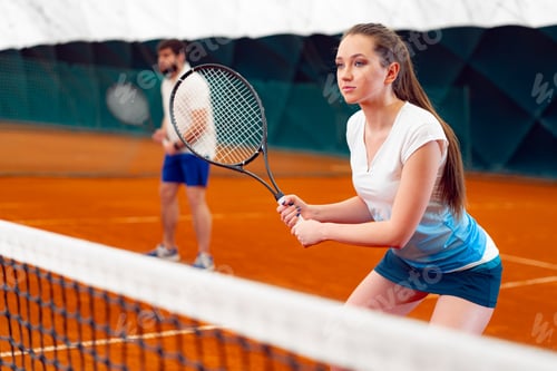 Preview: Pair of tennis players, man and woman waiting for service at indoor court