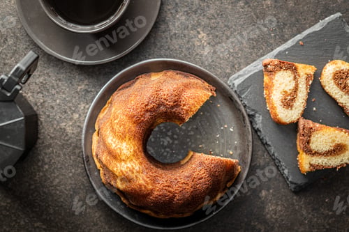 Preview: Sweet sponge cake. Bundt cake on dark table.