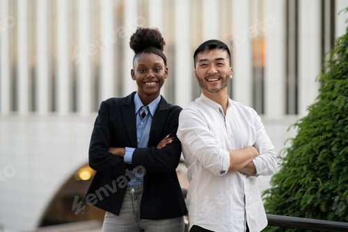 Preview: portrait business colleagues with arms crossed handsome young asian man young african american woman