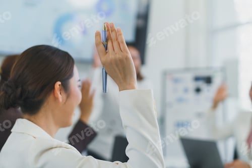 Preview: Businesswoman raising hand during a meeting asking a question