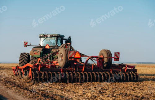 Preview: Agricultural machinery on the wheat field at daytime