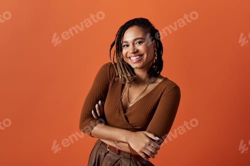 Preview: Confident young African American woman with braids in a vibrant studio setting