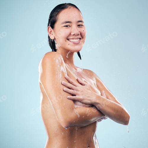 Preview: Skincare, shower portrait and Asian woman smile for cleaning in studio isolated on a blue backgroun
