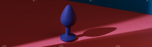Preview: Blue buttplug sex toy on a colorful background. Photo of anal toy for adult with