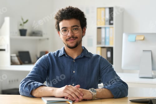 Preview: Young businessman working in office