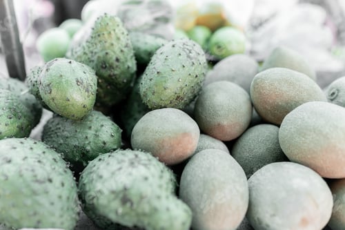 Preview: Close up of some green and red tomatoes in a street market stall