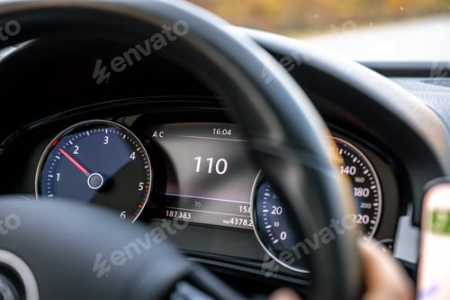 Preview: Steering wheel in a car close up, high speed driving on the road.