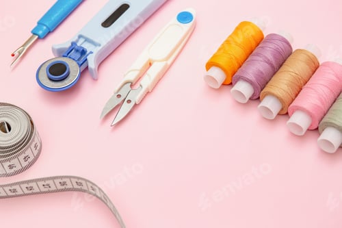 Preview: Colorful Sewing Threads and Tailor Tools on Pink Background