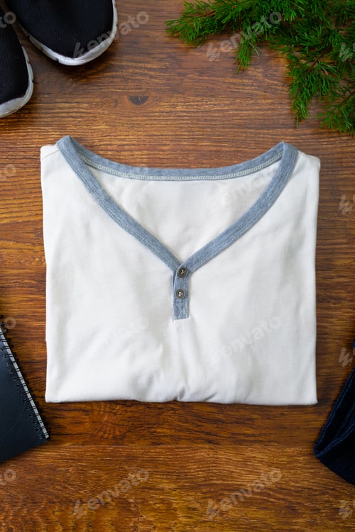 Preview: Composition of t-shirt, shoes and tree branches on wooden background