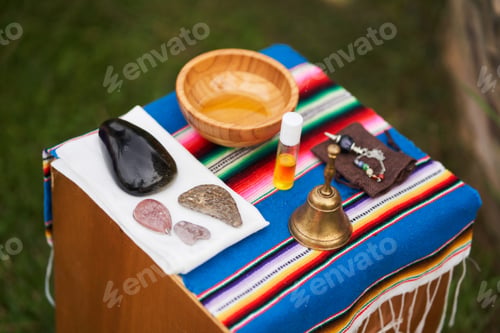 Preview: Massage therapist preparing natural oils and stones for relaxing treatment