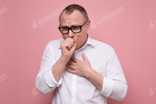Preview: Mature caucasian man coughing because of flu or grippe