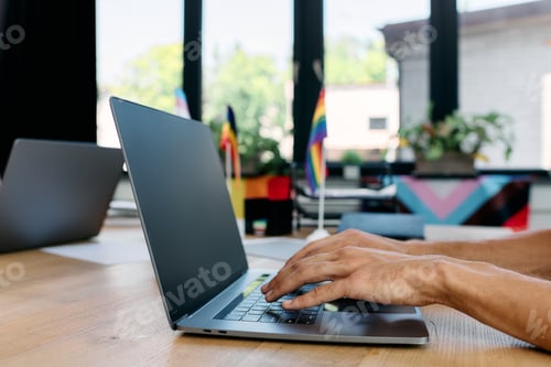 Preview: A stylish gay couple works together in a bright modern workspace surrounded by vibrant decor