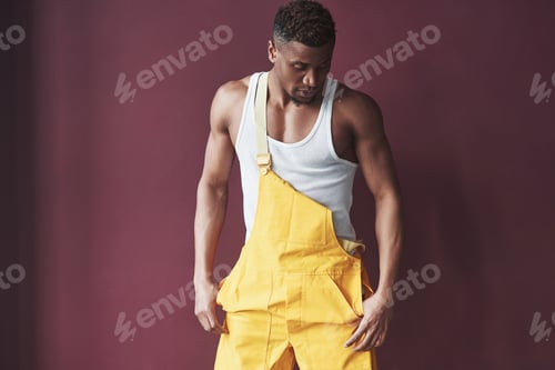 Preview: Fashionable modern man. Young african american worker in the yellow uniform have some job