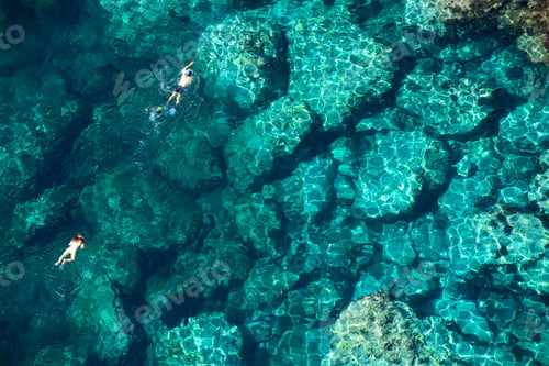 Preview: Drone view of a couple snorkeling in the sea
