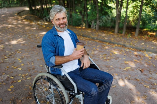 Preview: Inclusive Leisure: Person in Wheelchair Enjoying Coffee Amidst Nature