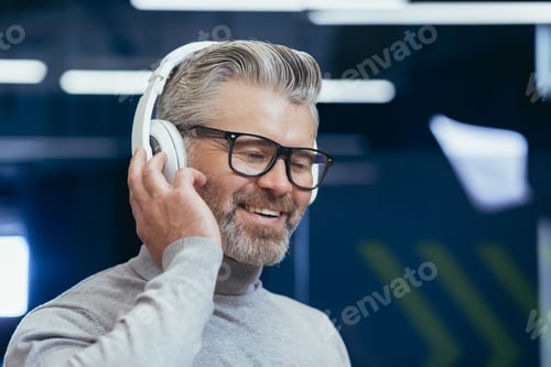 Preview: Close-up photo portrait of mature gray-haired businessman, gray-haired man in headphones listening