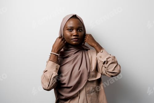 Preview: Muslim African businesswoman posing in studio on white background ad